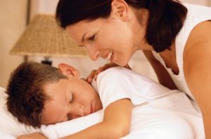 Mother with sleeping son stock photo