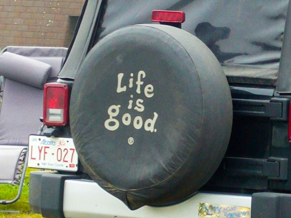 Jeep with wheel cover that says life is good.