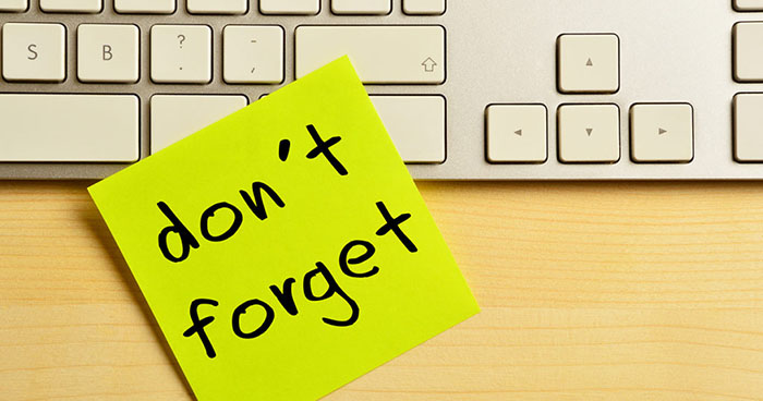 Don't Forget post it note on keyboard