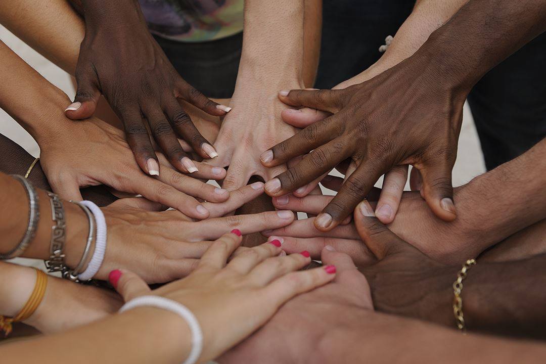 Group of hands stacked on top of each other