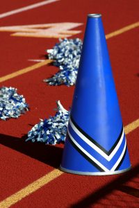Cheerleader pom poms and megaphone at a football game