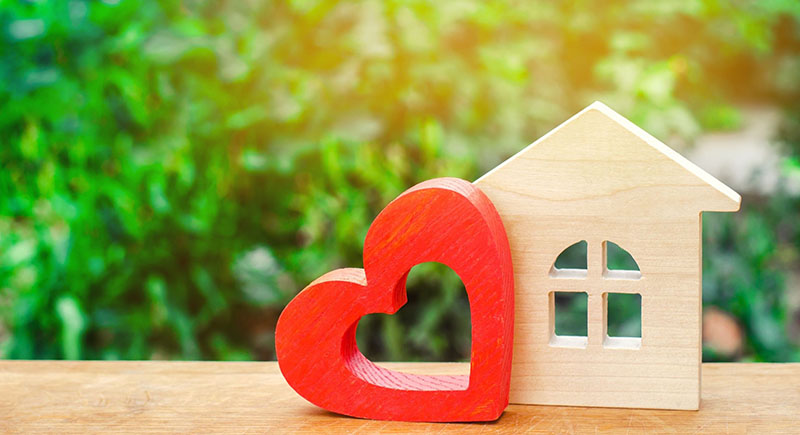 Wooden cut out of home and red heart shape