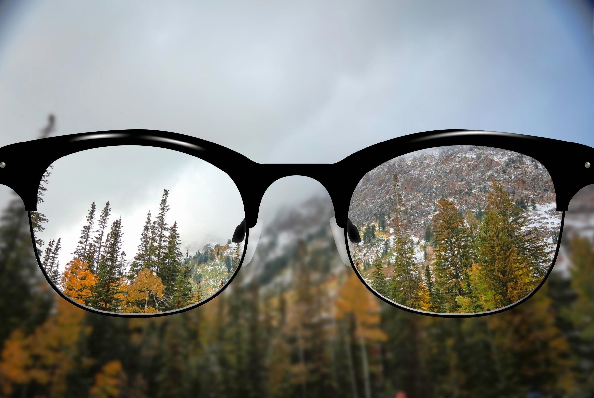 Blurry mountains with clear vision through eye glasses