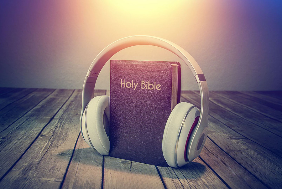 Bible with headphones on it